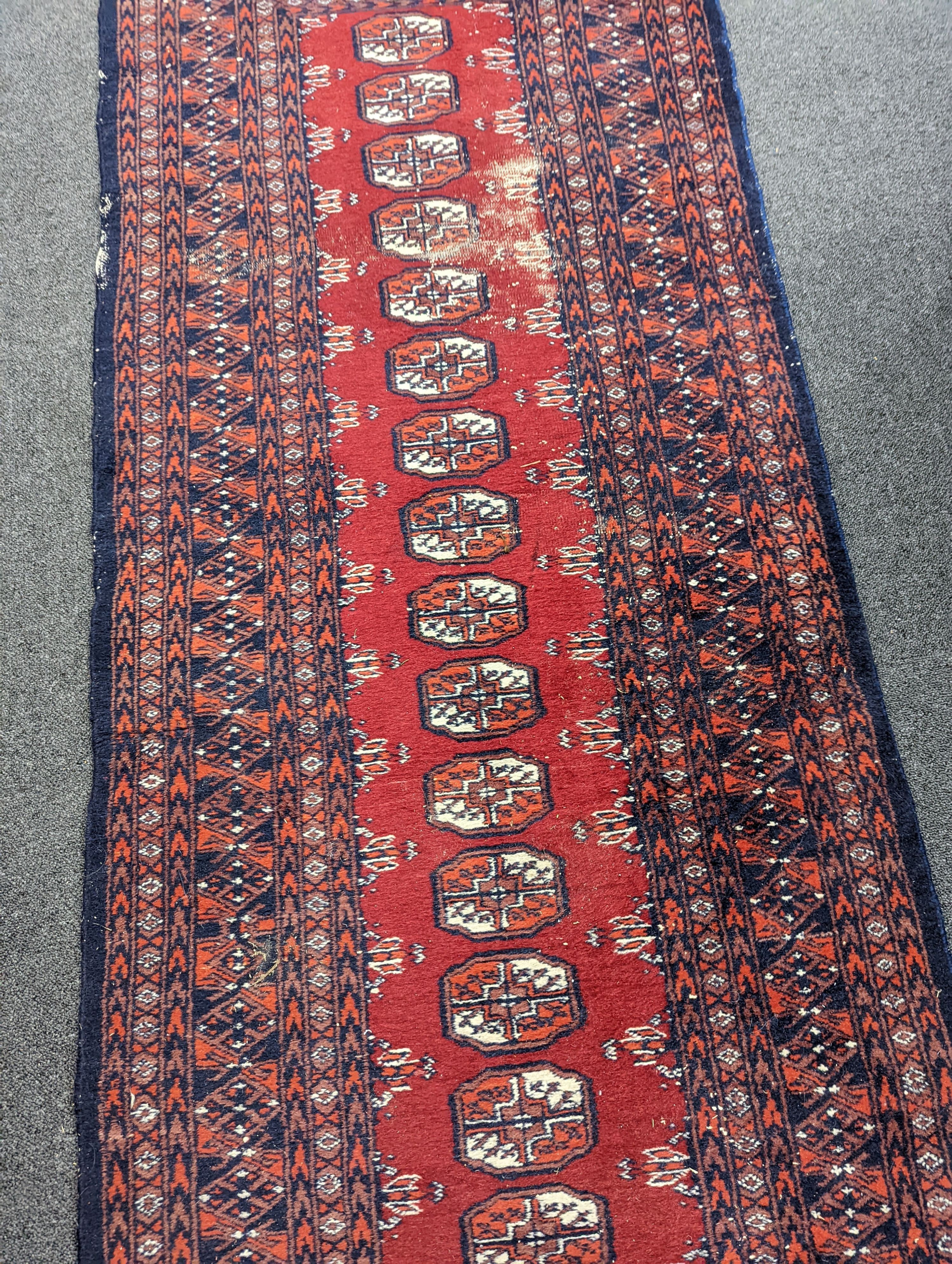 A Caucasian red ground rug and a Bokhara runner, rug 180 x 120 cms